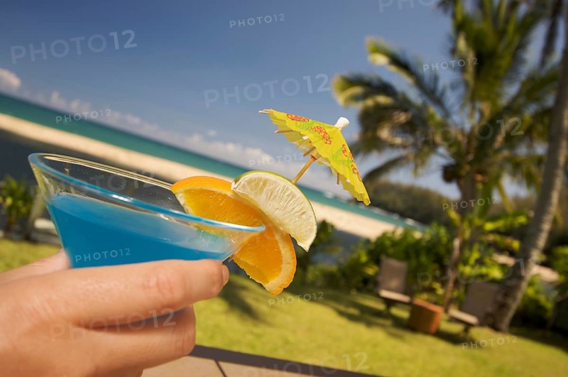 Woman with tropical drinks on Lanai