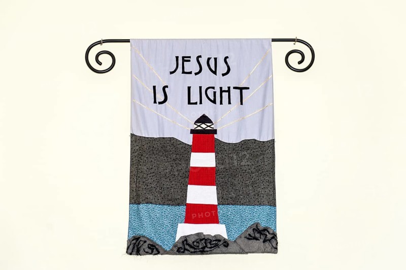 Mural with lighthouse and inscription Jesus is light in Bressay-Kirk church