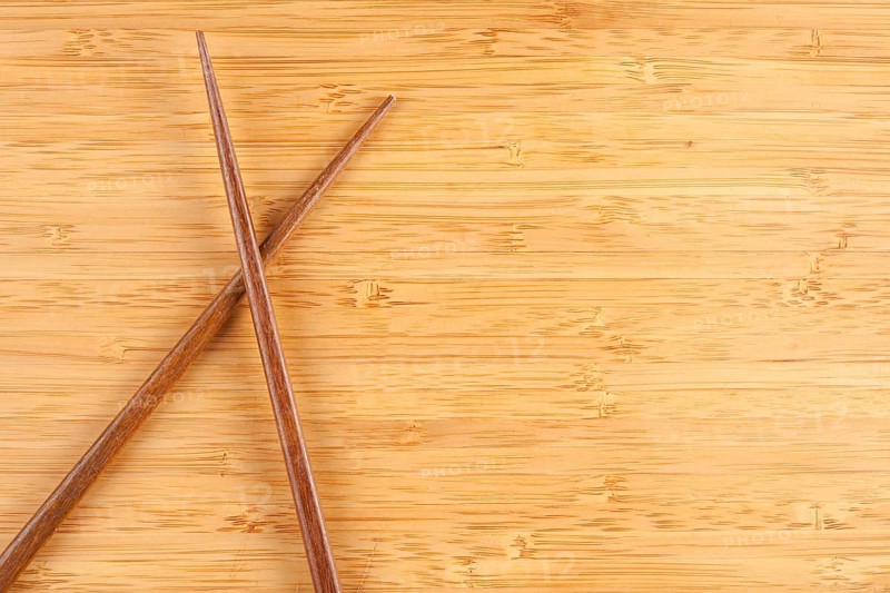 Bamboo textured surface background with chop sticks and plenty of room for text