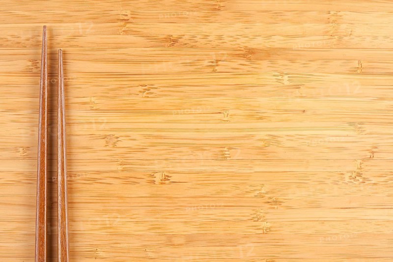 Bamboo textured surface background with chop sticks and plenty of room for text
