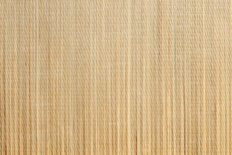 Uniform tan bamboo mat background overhead image