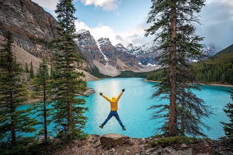 Young man jumps into the air and stretches his arms in the air