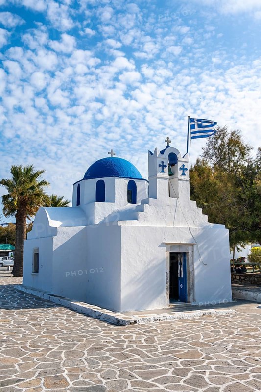 Blue and White Greek Orthodox Church Agios Nikolaos with Greek Flag