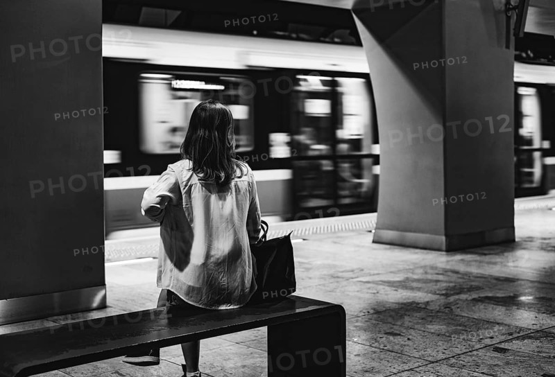 Girl sitting on the bench at metro station