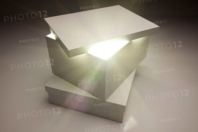 White box with lid revealing something very bright on a grey background