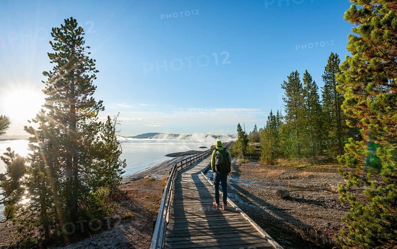 Hiker on boardwalk on the shore of the West Thumb of Yellowstone Lake