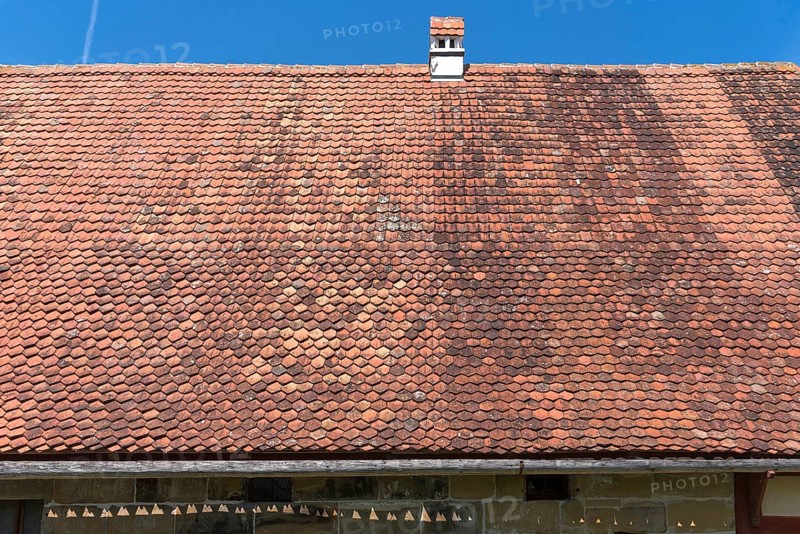 Roof with plain tiles on an old farmhouse from 1695