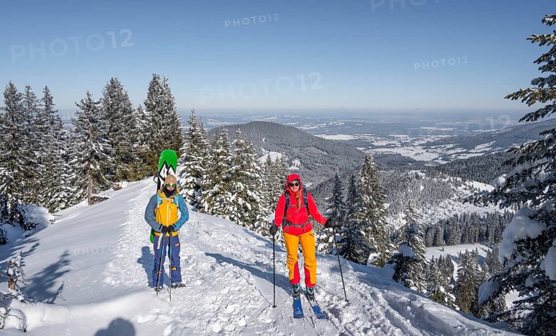 Young woman and man on ski tour