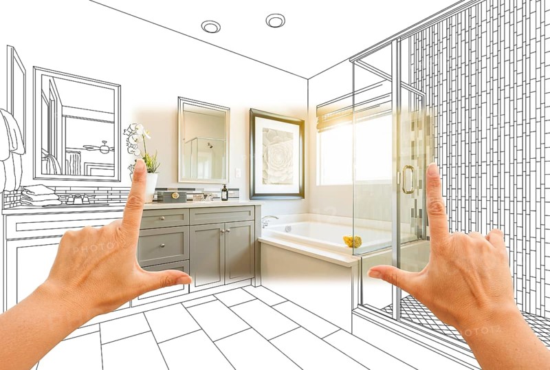 Hands framing custom master bathroom photo section with drawing behind