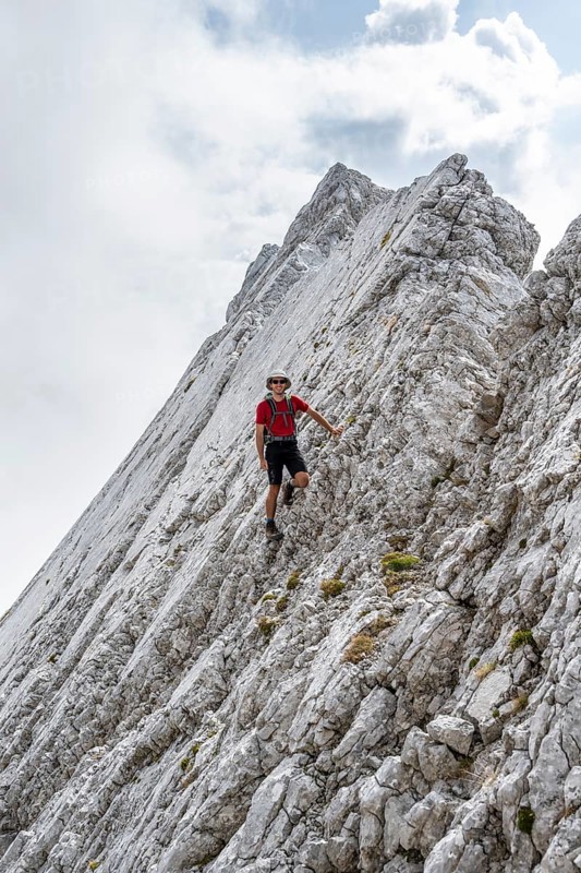 Young man at a rock face
