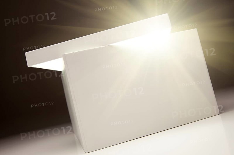 White box with lid revealing something very bright on a grey background