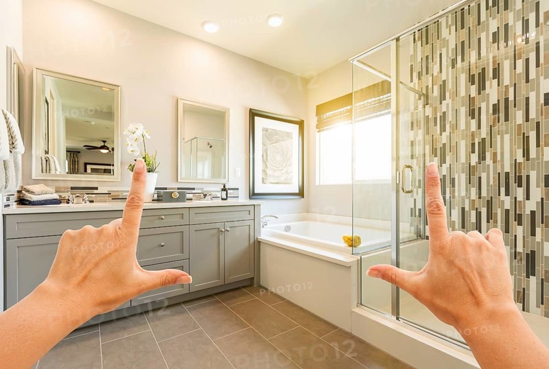 Hands framing custom master bathroom interior