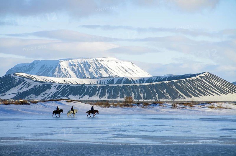 Riders in front of on partly frozen lake Myvatn