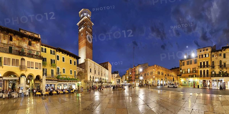 City square Piazza delle Erbe and former Roman Forum with fountain Fontana Madonna Verona and the medieval tower Torre dei Lamberti in the evening