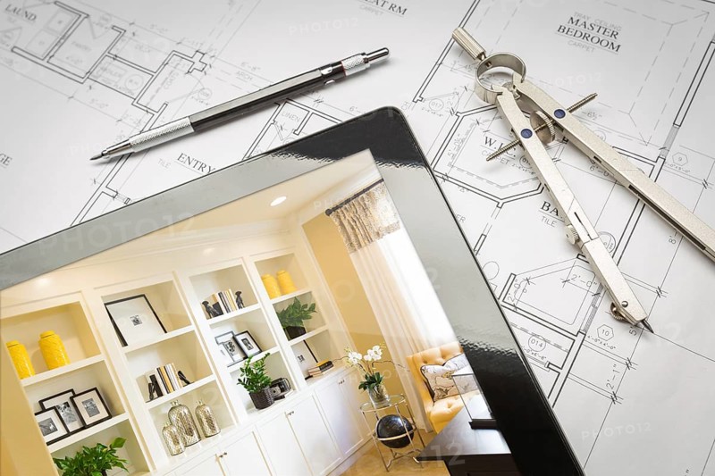 Computer tablet with finished built-in shelves and cabinets over house plans