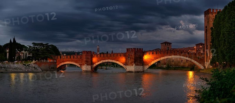 River Adige with the stone bridge Ponte Scaligero at sunset