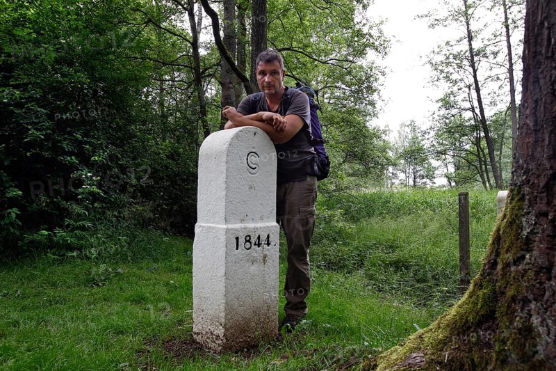 Hiker at the border stone