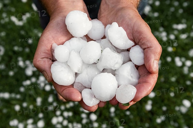 Golfball-sized hailstones in hands