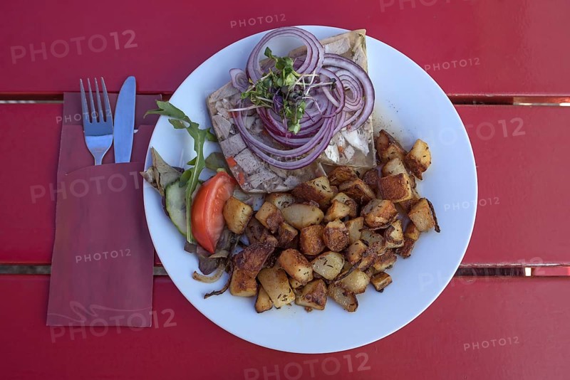 Brawn served with fried potatoes in a garden restaurant