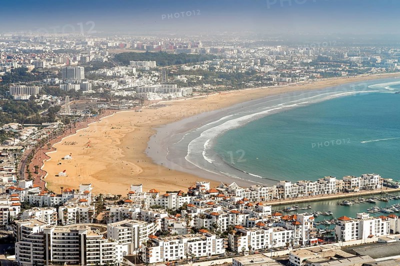 White modern architecture surrounding amazingly wide sandy beach in Agadir