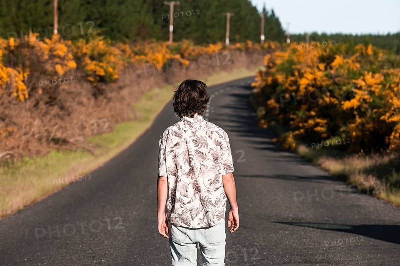Guy walking on a road