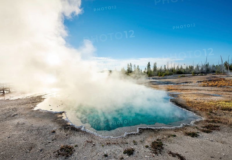 Steaming hot spring with turquoise water in the morning sun