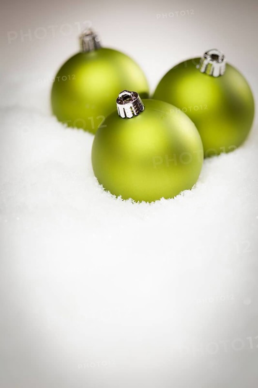 Beautiful matt green christmas ornaments on snow flakes room for your own text