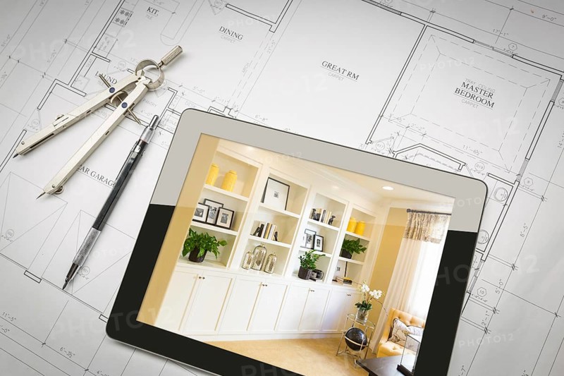 Computer tablet with finished built-in shelves and cabinets over house plans
