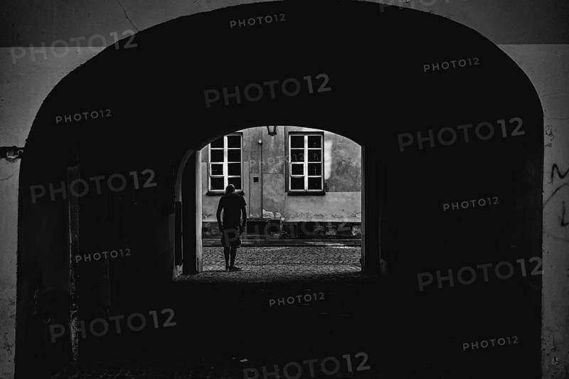 Man looking out of the yard gate