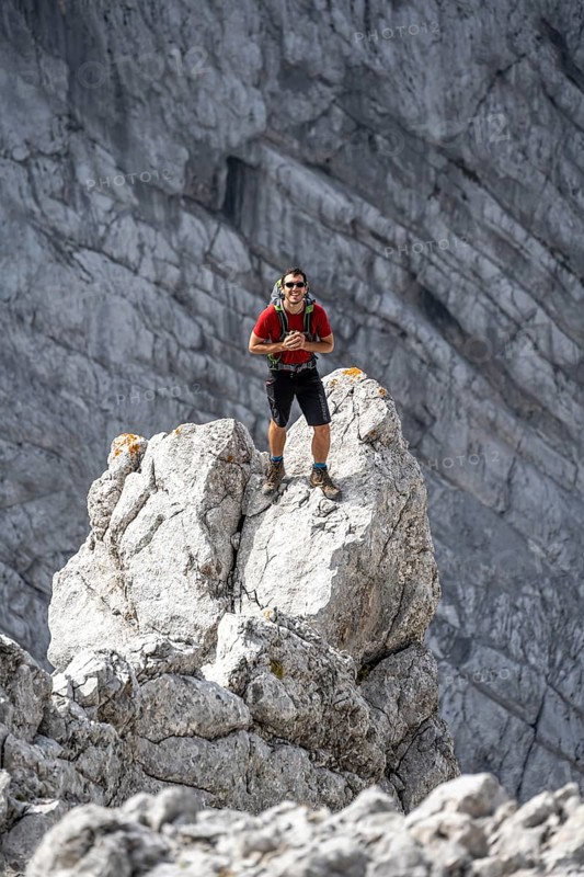 Young man standing on rocks