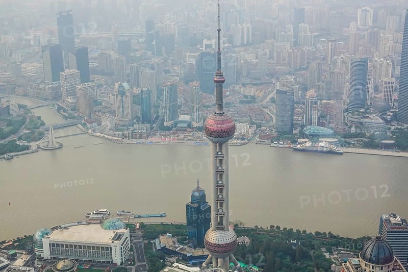 View from the highest observatory of the world on 562 meters height in the 632 meters high skyscraper Shanghai Tower on the special economic zone Pudong with the 468 meters high Oriental Pearl Tower the Huangpu River and the district Tilanqiao