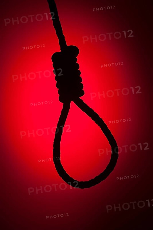 Silhouetted hangman's noose over red spot lit background