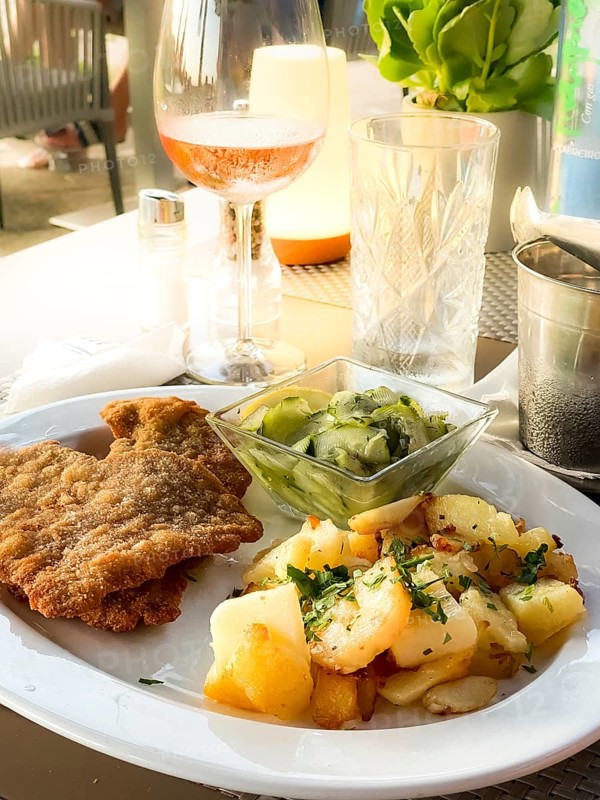 Original Viennese veal escalope with fried potatoes and cucumber salad