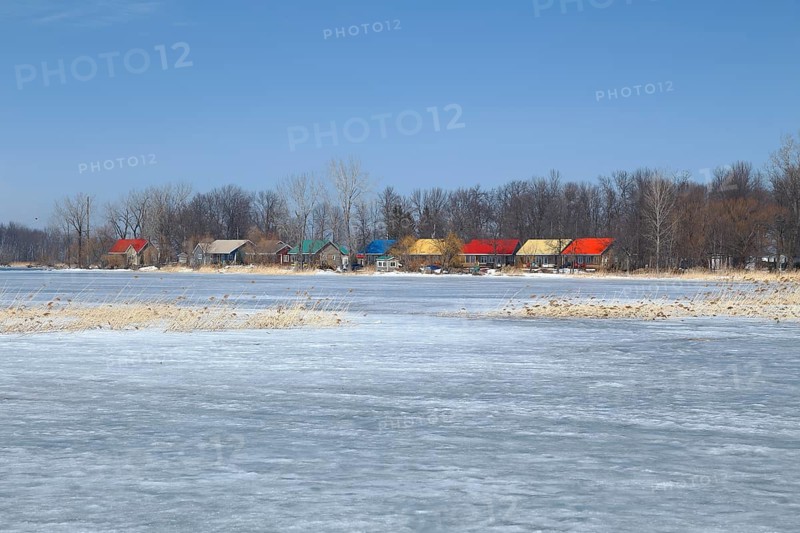 Colourful cottages on the frozen Saint Lawrence River