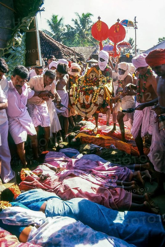 Poojari or priest walking on women in Mahasivaratri festival at poochiyur near Coimbatore