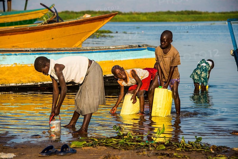 Children filling water in canisters at Lake Albert