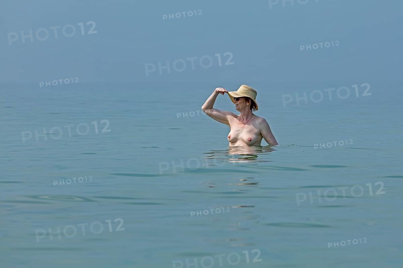 Older woman bathing naked