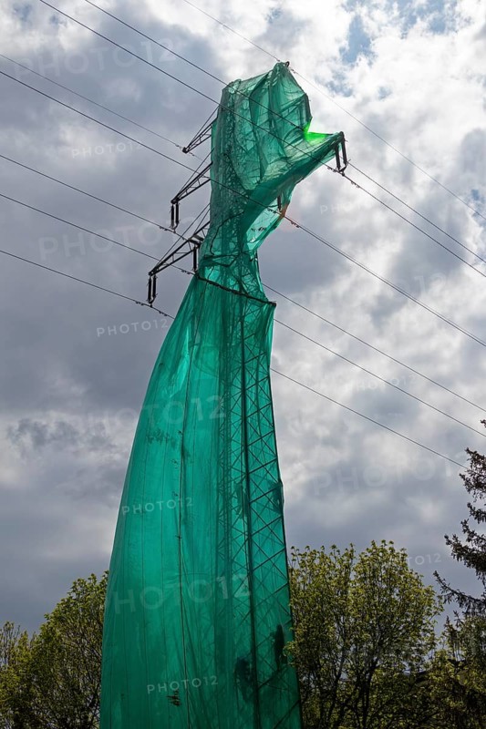 High voltage pylon covered with a tarpaulin due to maintenance work