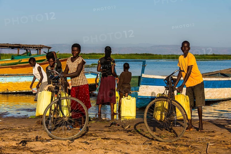 Children filling water in canisters at Lake Albert