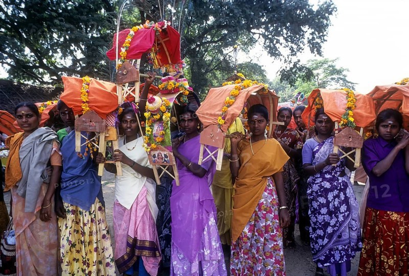 Women devotees carrying Kavadi on their shoulders to Palani on Thai Poosam day