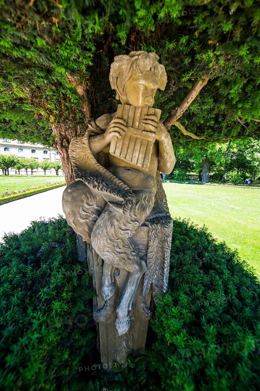 Statue under a tree in the Baroque gardens in the Wuerzburg Residence