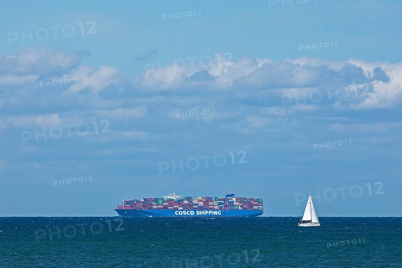 Container ship and sailing boat off Puttgarden