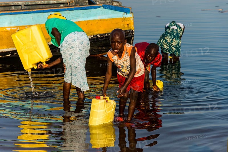 Children filling water in canisters at Lake Albert