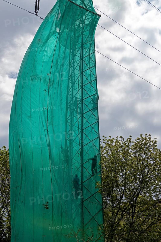High voltage pylon covered with a tarpaulin due to maintenance work