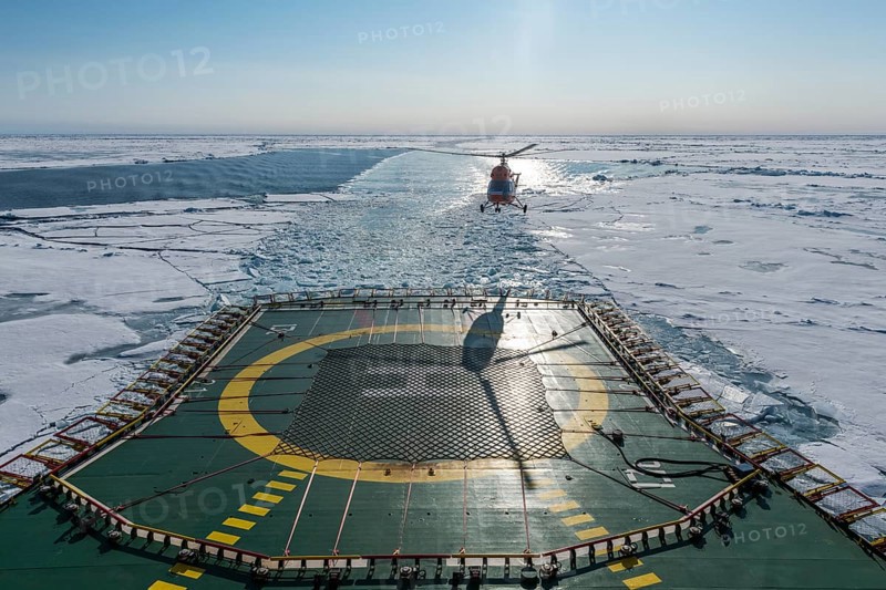 Helicopter on the Helipad of the Icebreaker '50 years of victory' on its way to the North Pole breaking through the ice