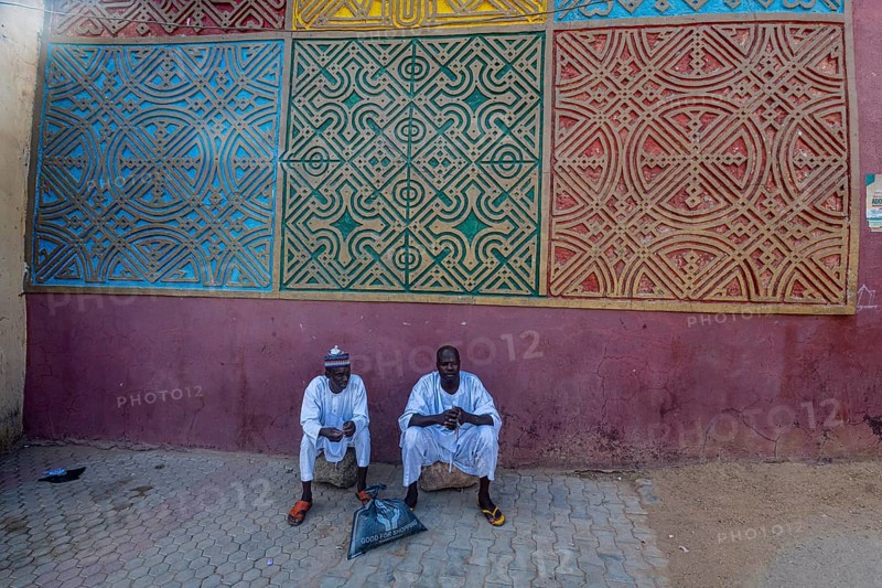 Men sitting at the entrance to Gidan Rumfa