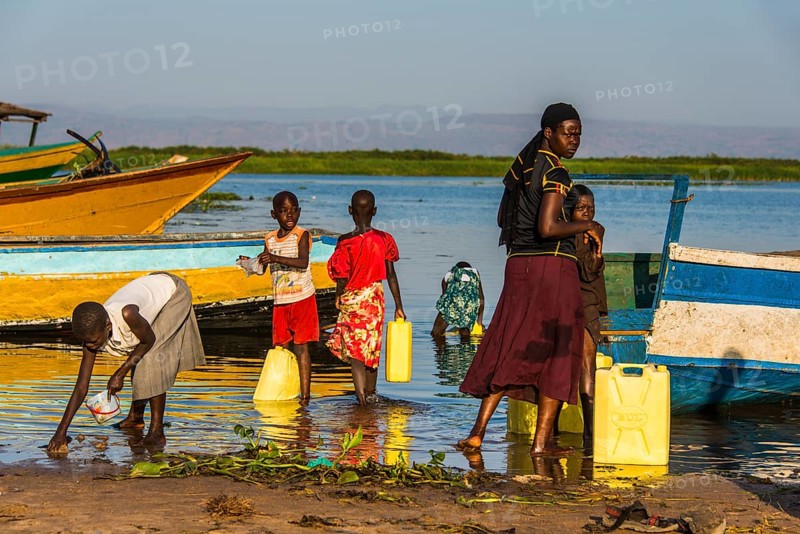 Children filling water in canisters at Lake Albert