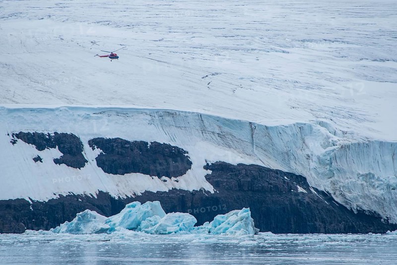 Helicopter flying over the giant icefield of Alexandra Land