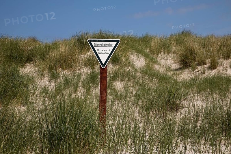 Dune landscape with sign for dune protection and the request not to enter