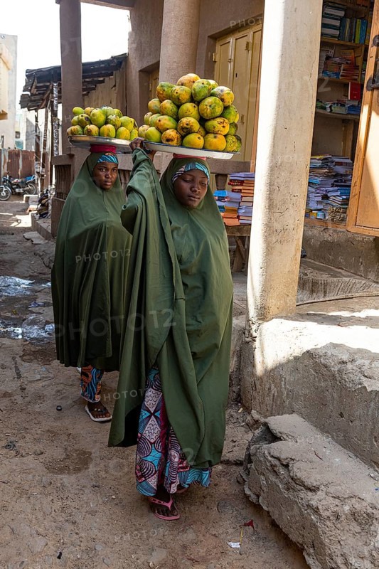 Women carrying fruits on their head